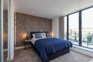 a bedroom with a bed and a large window at KSpace @ The Point in Sheffield
