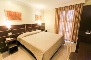 a hotel room with a bed and a window at Hotel Windsor in Sao Paulo +32 photos