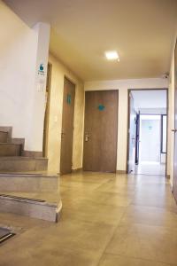 an empty room with stairs and doors in a building at Agora Suites Hotel, Check-in digital fácil con atención virtual 24h in Bogotá