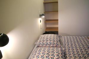 a small bedroom with a bed with a pillow at Casa Geayh in Marseillan