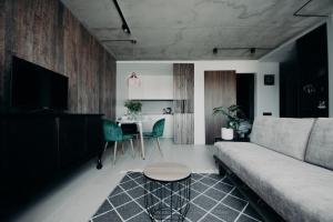 a living room with a couch and a table at ERTA Anykščių Namai in Anykščiai