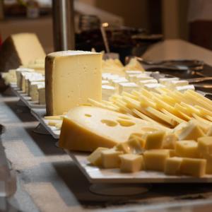 a bunch of cheese on a plate on a table at TUI Blue Isla Cristina Palace - Adults Recommended in Isla Cristina