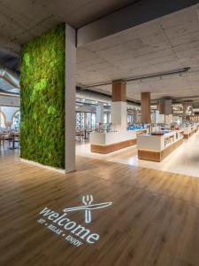 a large green wall in the middle of a lobby at TUI Blue Isla Cristina Palace - Adults Recommended in Isla Cristina