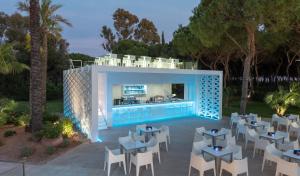 a resort with a pool and tables and chairs at TUI Blue Isla Cristina Palace - Adults Recommended in Isla Cristina