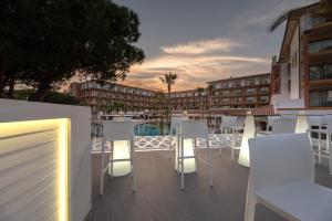 a balcony with white chairs and a building at TUI Blue Isla Cristina Palace - Adults Recommended in Isla Cristina