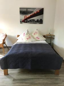 a bedroom with a black bed with two pillows at Haus Sonnenschein Str 10 in Timmendorfer Strand