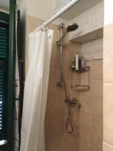 a shower with a shower curtain in a bathroom at L ' CANTON B & B in Colonnata +25 photos