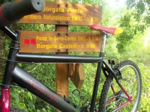 een fiets geparkeerd voor een bord bij Agriturismo A Veggia Vigna in Garlenda