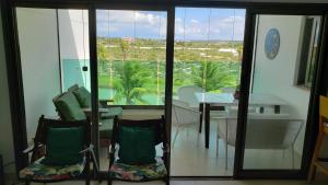 a dining room with a view of a table and chairs at Iberostate Praia do Forte Apartamento in Praia do Forte