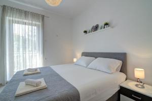 Postel nebo postele na pokoji v ubytování Apartman Luka