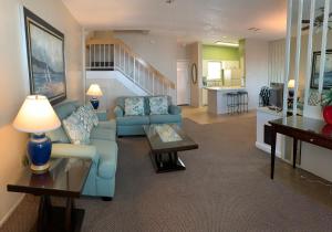 a living room with a blue couch and a table at Four Seasons on the Gulf in Galveston