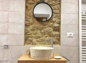 a bathroom with a sink and a mirror at Le Camere Del Borgo in Montescudaio
