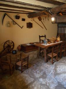 a room with a wooden table and chairs in a room at Apartamentos Rurales Casa del Tio Juan in Olocau del Rey