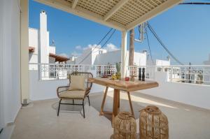 a table and chairs on the balcony of a house at Smirida Suites in Naxos Chora