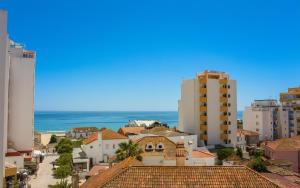 a view of a city with buildings and the ocean at Lovely oceanview beach house in Portimão