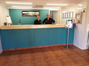 two men standing at a counter in a dental office at Kalbarri Edge Resort in Kalbarri