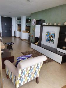 a living room with a couch and a table at Departamento frente al mar en Manta-Barbasquillo con espectacular vista in Manta