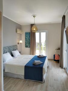 a bedroom with a large bed and a large window at Lilly Apartments in Athens