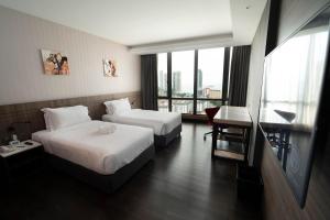 Postel nebo postele na pokoji v ubytování Jazz Hotel Penang