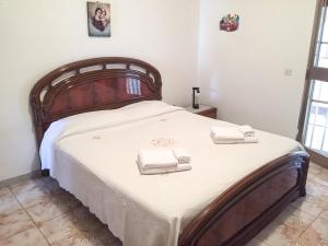 a bedroom with a bed with two towels on it at Villa Torretta - La casa di Luca in Marina di Lizzano
