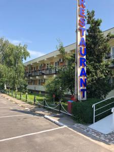 a hotel sign in front of a parking lot at Motel Prietenia in Giurgiu