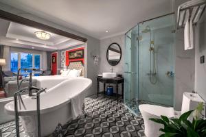 a bathroom with a bath tub and a shower at Acoustic Hotel & Spa in Hanoi
