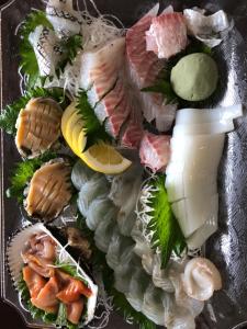a plate of food with seafood and a drink at villa chillon in Shodoshima