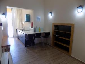 a kitchen with a counter and a island in a room at Souvlakis Pool Suites (S.P.S) in Chania