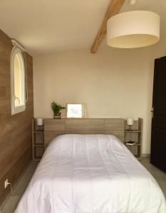 a bedroom with a large white bed in it at Saberic in Vence