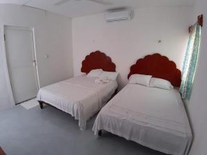 Postel nebo postele na pokoji v ubytování Habitaciones Chiquil Ha