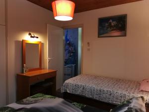 a bedroom with two beds and a sink and a mirror at Siamese Villa in Paralimni