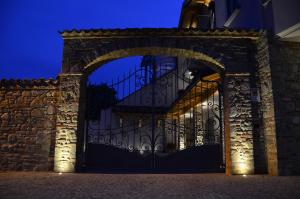 an entrance to a building with a wrought iron gate at La Rocca in Carrù
