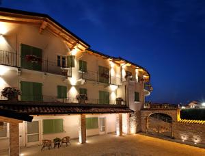 a large building with lights on it at night at La Rocca in Carrù