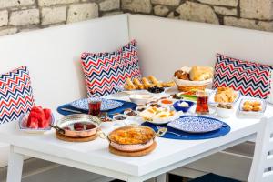 a table filled with breakfast food on a table at ALAÇATI VİLLAPERİ BUTiK OTEL in Alacati