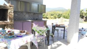 a patio with a table and chairs and a kitchen at Casale Diletta in Castiadas