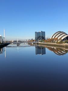 a large body of water with buildings in the background at SEC/ Hydro Two Bed Flat With Free parking and Great View in Glasgow