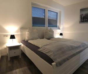 ein Schlafzimmer mit einem weißen Bett und einem Fenster in der Unterkunft Ferienwohnung Calla in Erfurt