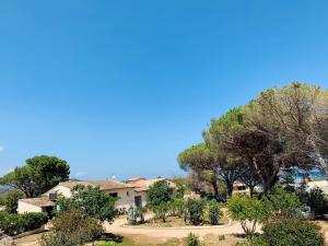 a house on a hill with trees and bushes at Bungalows Filippi in Porto-Vecchio