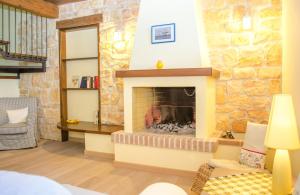 a fireplace in a living room with a stone wall at Hausclaudia in Cerveteri