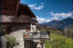 a building with a balcony on the side of it at Agriturismo Luloc in Buglio in Monte