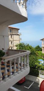 a white balcony with a view of the ocean at Primorsko Apartments in Primorsko