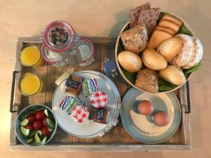 a tray of food with bread and other foods on it at 84huis in Amstelveen