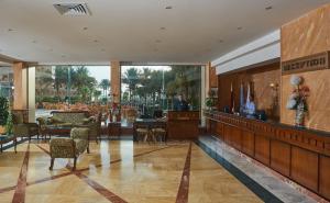 a lobby of a hotel with tables and chairs at Sea Star Beau Rivage Hotel in Hurghada +152 photos