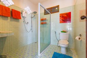 a bathroom with a shower and a toilet at Seaboard Bungalow in Haad Yao