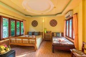 Postel nebo postele na pokoji v ubytování Seaboard Bungalow