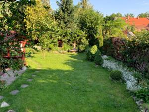 a yard with a fence and green grass and trees at Family room for 4-6 person in Budapest
