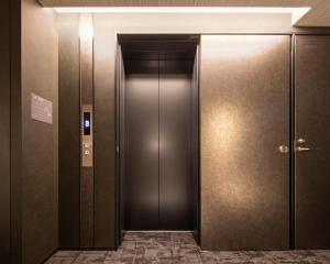 an elevator in a building with its door open at Act Hotel Shibuya in Tokyo