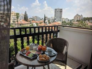 a table with breakfast food on top of a balcony at Lordos Hotel Apartments Nicosia in Nicosia