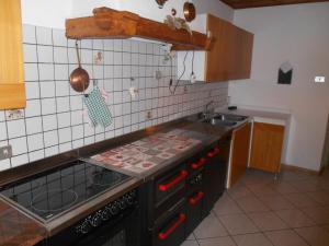 a kitchen with a sink and a stove top oven at CASA CAMPAGNA in Cavalese