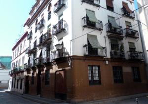 a tall building with balconies on the side of it at Rodo Arenal in Seville